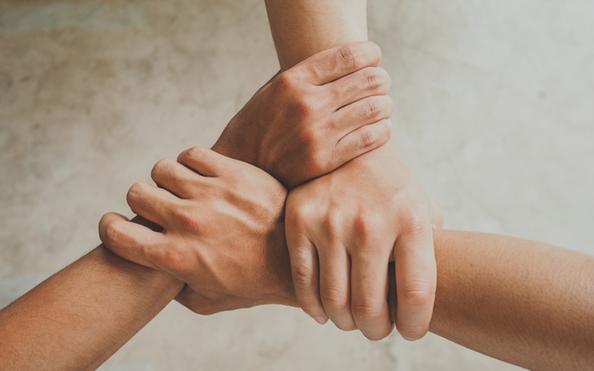 Three human join hands together, collaboration concept of business and education teamwork, soft focus and vintage color tone process
