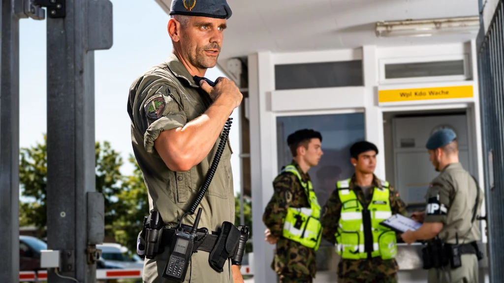 Military Police officer speaking into a TPH900 radio