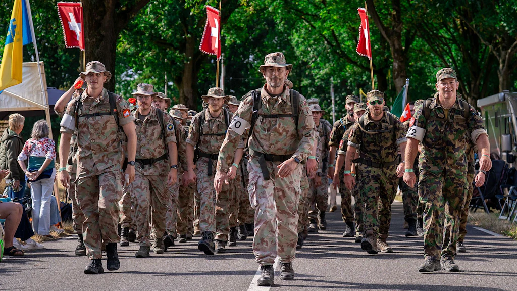 Drei Marschgruppen in Schweizer Uniformen beim Durchmarsch in Groesbeek