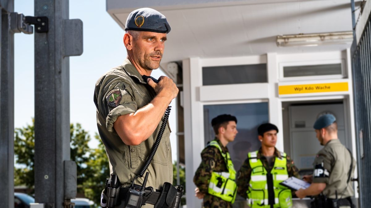 Military Police officer speaking into a TPH900 radio