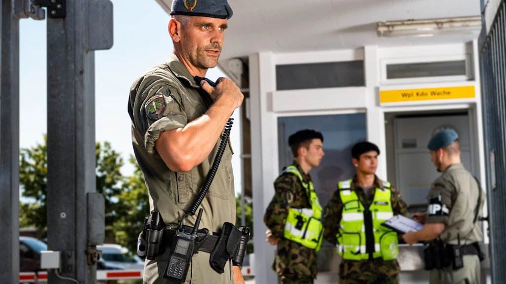 Military Police officer speaking into a TPH900 radio