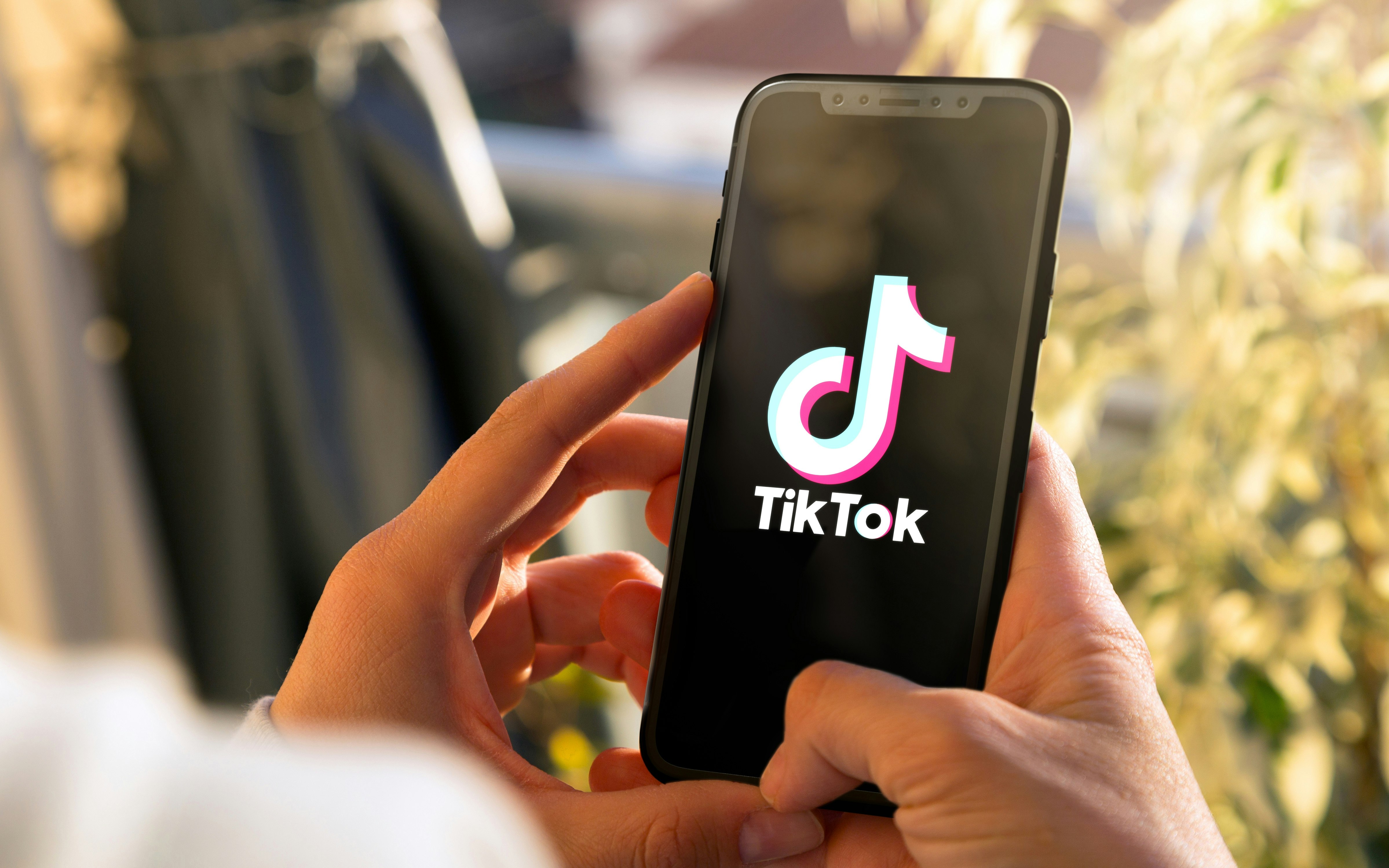 Tiktok on mobile phone Screen. Young woman holding a Smart Phone with Tik Tok app. ROSARIO, ARGENTINA -MARCH 15, 2023.
