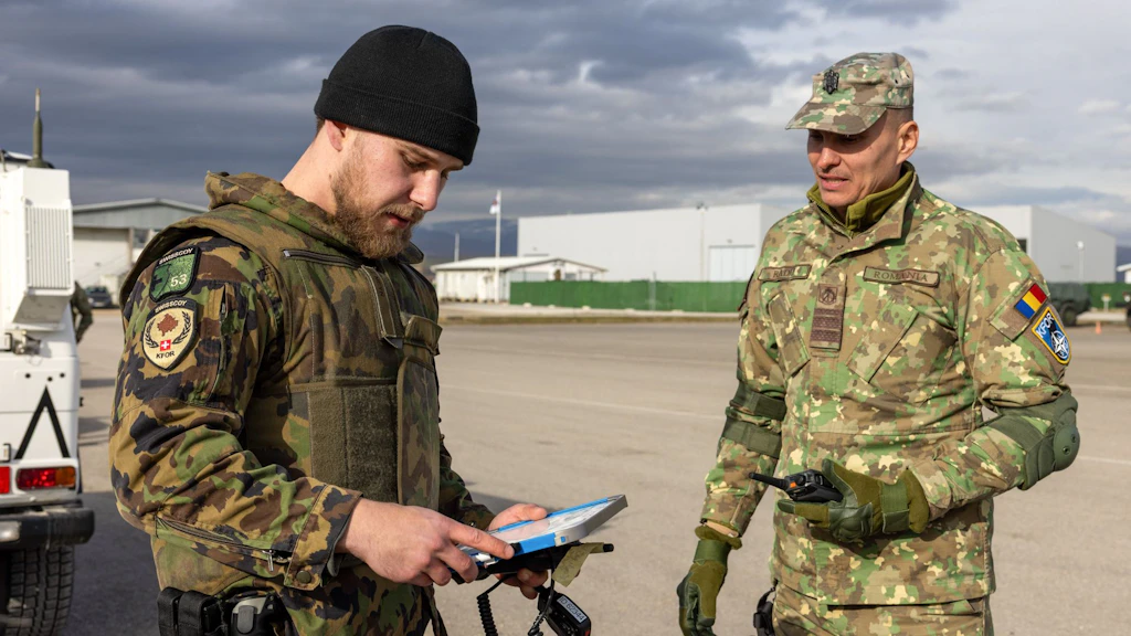I militari dell’MSD multinazionale discutono la procedura e coordinano i processi.